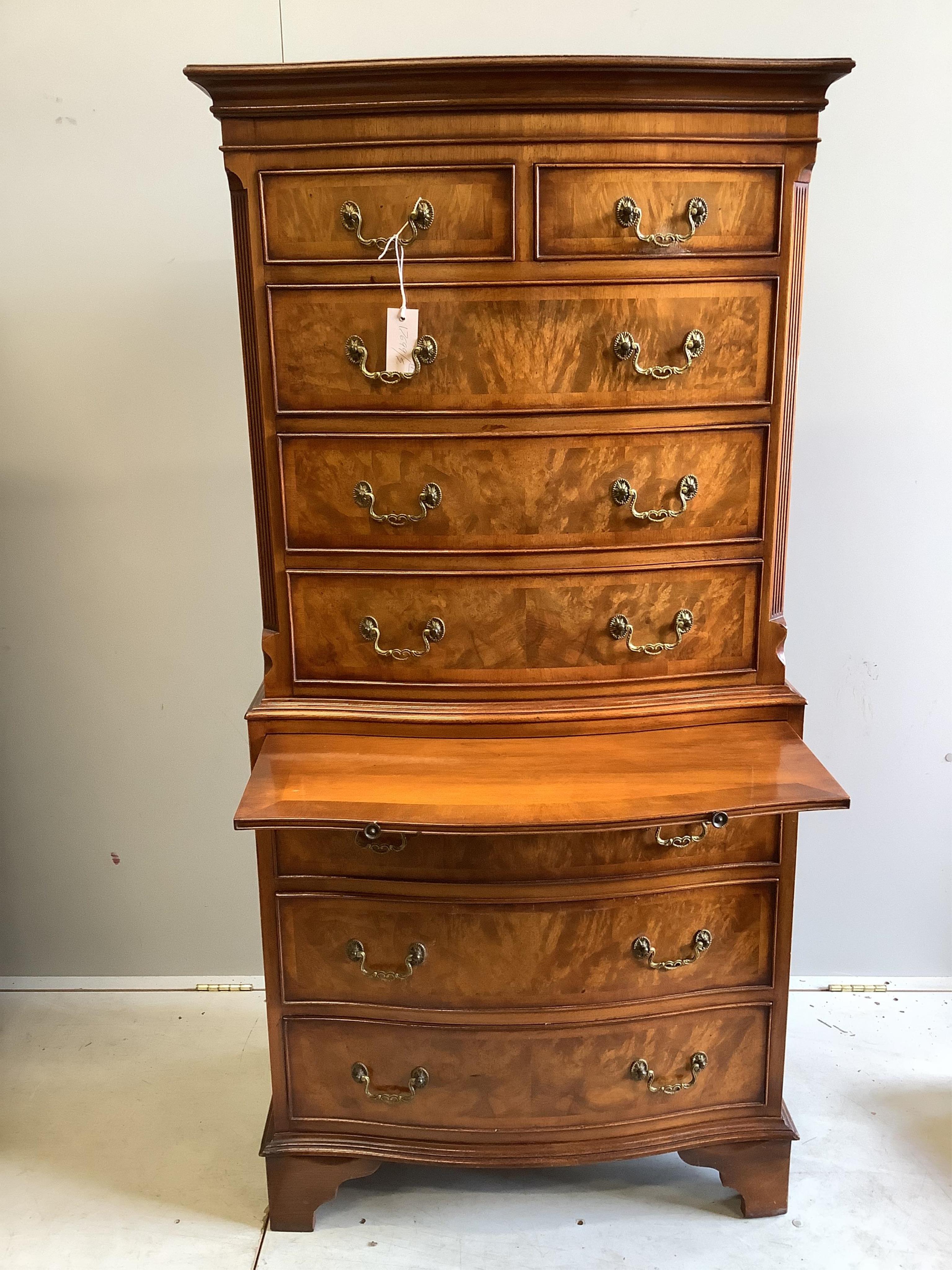 A pair of small reproduction George III style walnut bow front walnut chest on chests, width 72cm, depth 44cm, height 152cm. Condition - good